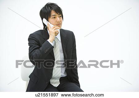 Stock Photo - Businessman Using a Mobile Phone, Front View, Copy Space . Fotosearch