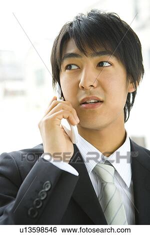 Stock Photograph - Businessman Using Mobile Phone, Front View. Fotosearch