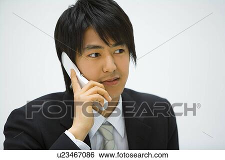 Stock Photograph - Businessman Using Mobile Phone, Front View. Fotosearch