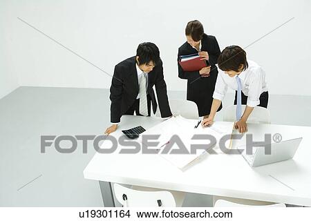 Businessmen and Businesswoman In Meeting, High Angle View View Large Photo Image Picture - Businessmen and Businesswoman In Meeting, High Angle View. Fotosearch