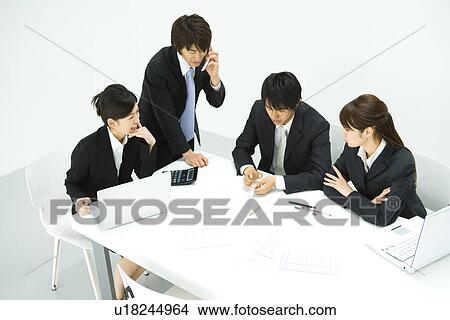 Picture - Businessmen and Businesswomen In Meeting, High Angle View. Fotosearch