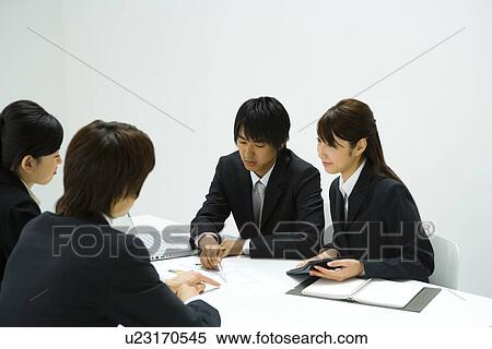 Stock Photography - Businessmen and Businesswomen In Meeting, Side View. Fotosearch