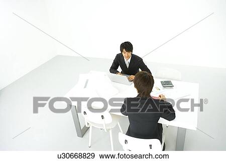 Businessmen In Meeting, High Angle View View Large Photo Image Stock Photo - Businessmen In Meeting, High Angle View. Fotosearch