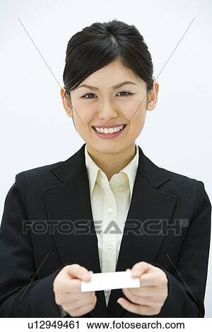 Stock Image - Businesswoman Exchanging Business Cards, Smiling, Three Quarter Length, Front View. Fotosearch