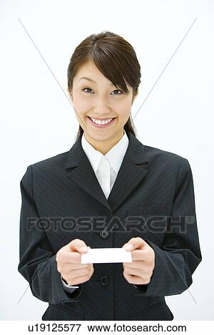 Businesswoman Exchanging Business Cards, Smiling, Three Quarter Length, Front View View Large Photo Image Stock Photo - Businesswoman Exchanging Business Cards, Smiling, Three Quarter Length, Front View. Fotosearch