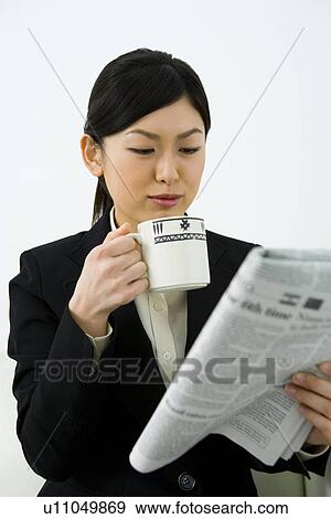 Businesswoman Reading English Newspaper With Holding a Cup, Differential Focus, Waist Up, Front View View Large Photo Image Stock Photo - Businesswoman Reading English Newspaper With Holding a Cup, Differential Focus, Waist Up, Front View. Fotosearch