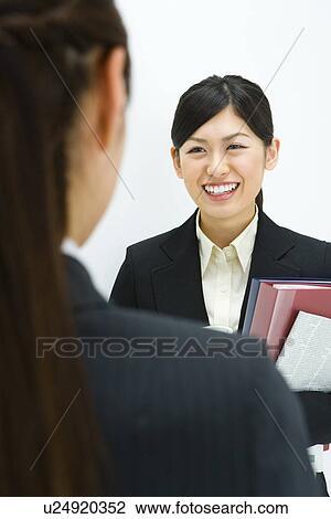 Stock Image - Businesswoman Talking, Front View, Rear View, Head and Shoulder, Differential Focus. Fotosearch