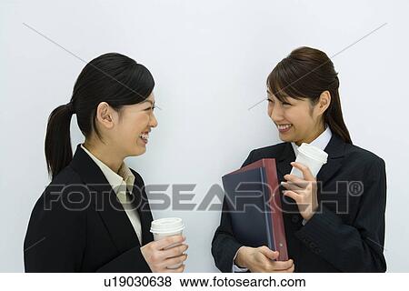 Stock Photo - Businesswomen Talking, Side View, Head and Shoulder. Fotosearch