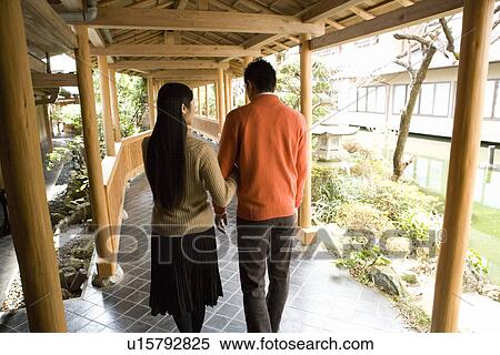 Stock Photography - Japanese couple at the corridor of the Japanese inn, rear view, Japan. Fotosearch