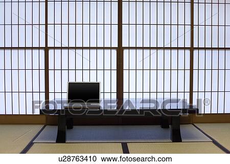 Stock Image - Laptop on the table in Japanese style room, front view, Japan. Fotosearch