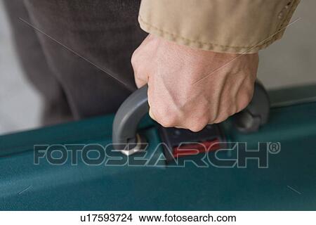 Man holding a suitcase, high angle view, close up, Japan View Large Photo Image Picture - Man holding a suitcase, high angle view, close up, Japan. Fotosearch