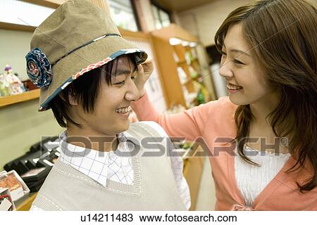 Young couple in the shop of a hotel, man wearing hat, side view, Japan View Large Photo Image Stock Image - Young couple in the shop of a hotel, man wearing hat, side view, Japan. Fotosearch