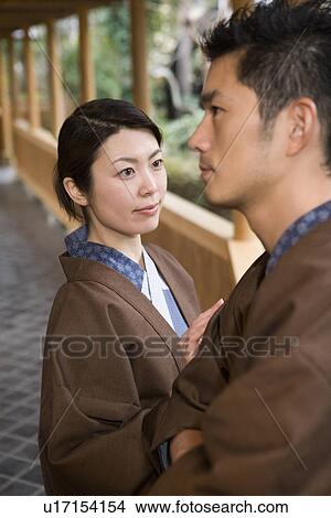 Picture - Japanese couple in Yukata at the corridor of the Japanese inn, side view, Japan. Fotosearch
