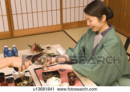 Japanese couple in Yukata having dinner, man pouring beer, high angle view, Japan View Large Photo Image Stock Image - Japanese couple in Yukata having dinner, man pouring beer, high angle view, Japan. Fotosearch