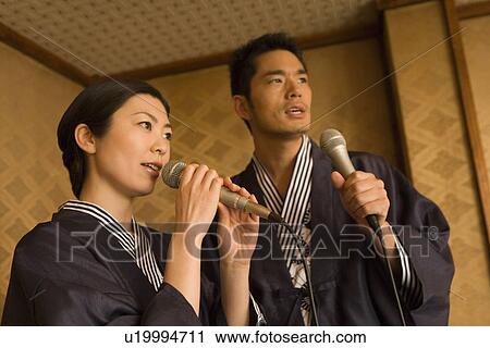 Stock Image - Japanese couple singing in Yukata, front view, side view, Japan. Fotosearch