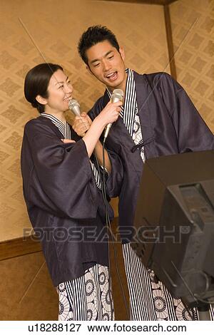 Stock Photo - Japanese couple singing in Yukata, front view, side view, Japan. Fotosearch