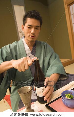 Man in Yukata opening a beer bottle, front view, Japan View Large Photo Image Stock Photography - Man in Yukata opening a beer bottle, front view, Japan. Fotosearch