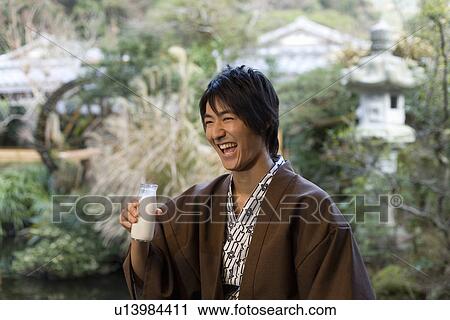 Man in Yukata smiling and holding a bottle of milk, front view, Japan View Large Photo Image Stock Image - Man in Yukata smiling and holding a bottle of milk, front view, Japan. Fotosearch