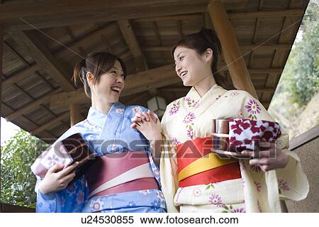 Two women in Yukata holding wooden tubs, low angle view, Japan View Large Photo Image Stock Photography - Two women in Yukata holding wooden tubs, low angle view, Japan. Fotosearch