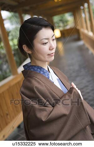 Woman in Yukata at the corridor of the Japanese inn, side view, differential focus, Japan View Large Photo Image Stock Photography - Woman in Yukata at the corridor of the Japanese inn, side view, differential focus, Japan. Fotosearch