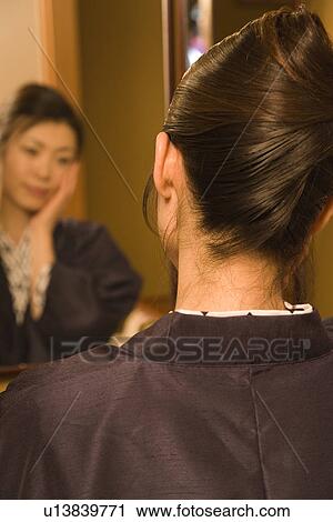 Woman in Yukata looking into the mirror, rear view, Japan View Large Photo Image Stock Image - Woman in Yukata looking into the mirror, rear view, Japan. Fotosearch