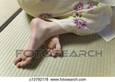 Stock Photo - Woman in Yukata sitting on Tatami mat, high angle view, close up, Japan. Fotosearch