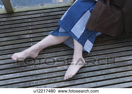 Woman in Yukata sitting on wooden terrace, high angle view, Japan View Large Photo Image Stock Image - Woman in Yukata sitting on wooden terrace, high angle view, Japan. Fotosearch