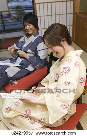 Young couple in Yukata writing Japanese poem, side view, Japan View Large Photo Image Stock Photo - Young couple in Yukata writing Japanese poem, side view, Japan. Fotosearch