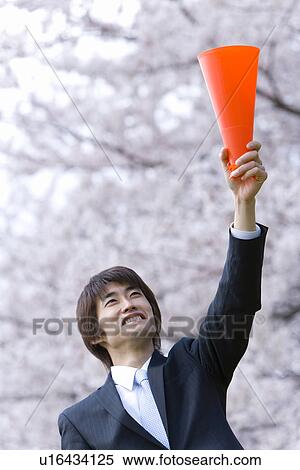Stock Photography - Businessman Lifting A Megaphone, Low Angle View, Head and Shoulder. Fotosearch