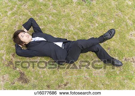 Businessman Lying On Grass View Large Photo Image Stock Photograph - Businessman Lying On Grass. Fotosearch