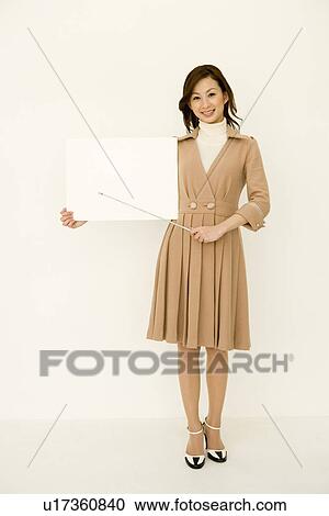 Portrait of a woman holding blank board and pointer, looking at camera, front view, white background View Large Photo Image Stock Image - Portrait of a woman holding blank board and pointer, looking at camera, front view, white background. Fotosearch
