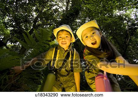 Stock Image - Boy and girl in forest. Fotosearch