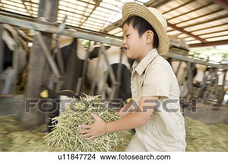 Picture - Boy holding grass and running. Fotosearch