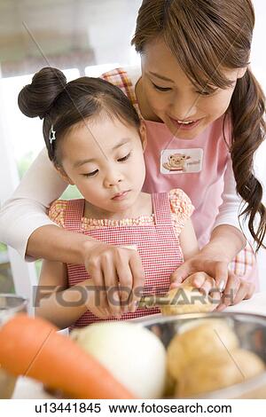 Daughter helping mother cook View Large Photo Image Stock Photography - Daughter helping mother cook. Fotosearch