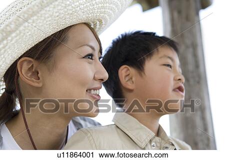 Stock Image - Mother and son looking away. Fotosearch