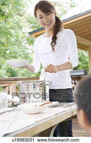 Mother serving curry View Large Photo Image Stock Image - Mother serving curry. Fotosearch