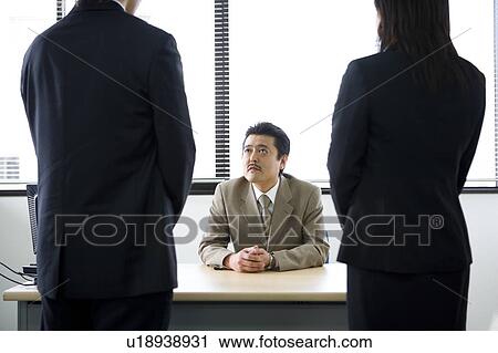 Businessman talking to colleagues View Large Photo Image Stock Image - Businessman talking to colleagues. Fotosearch