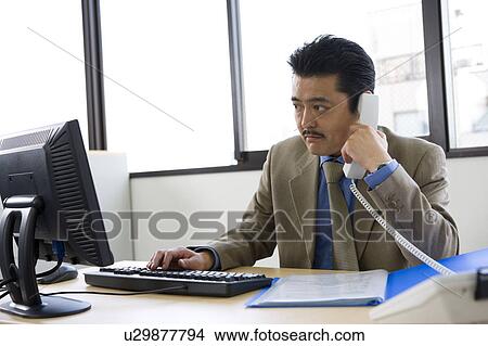 Picture - Businessman working in Office. Fotosearch