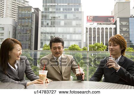 Stock Photo - Three business people drinking coffee. Fotosearch