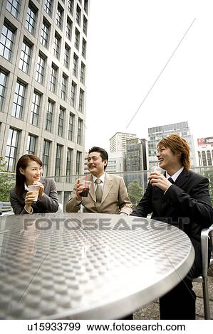 Stock Photo - Three business people drinking coffee. Fotosearch