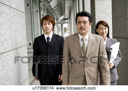 Picture - Three business people walking. Fotosearch