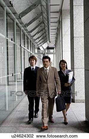 Three business people walking View Large Photo Image Stock Image - Three business people walking. Fotosearch
