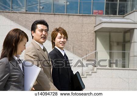 Stock Photo - Three business people walking. Fotosearch