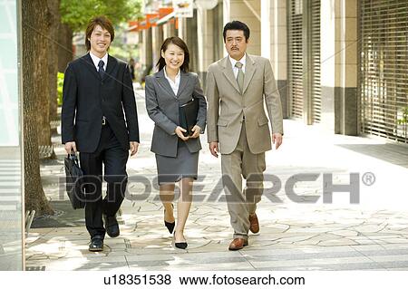 Stock Photo - Three business people walking. Fotosearch