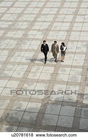 Three business people walking View Large Photo Image Stock Photo - Three business people walking. Fotosearch