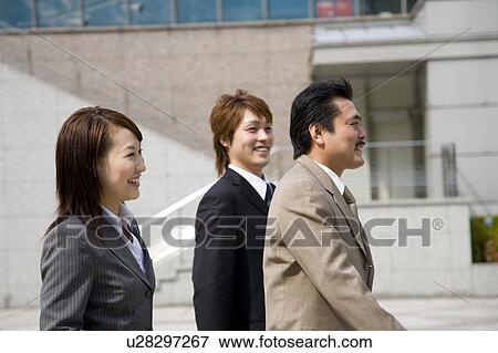 Three business people walking View Large Photo Image Stock Photo - Three business people walking. Fotosearch