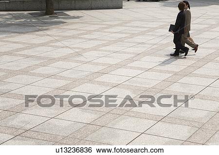 Stock Photograph - Three business people walking. Fotosearch