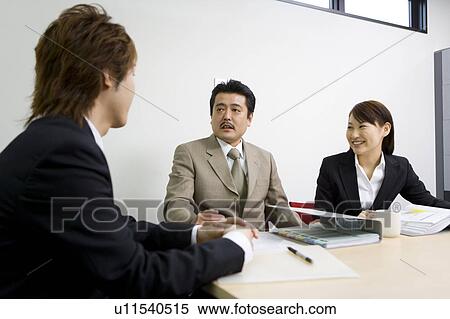 Three people discussing in meeting room View Large Photo Image Stock Photography - Three people discussing in meeting room. Fotosearch