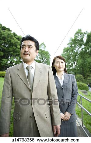 Two business people walking View Large Photo Image Stock Photograph - Two business people walking. Fotosearch