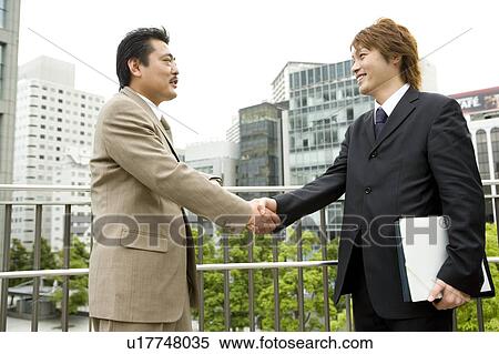 Two businessmen shaking hands View Large Photo Image Stock Photography - Two businessmen shaking hands. Fotosearch